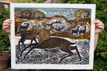 Load image into Gallery viewer, Some holds up the print Knepp Red Deer by Angela Harding