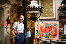 Load image into Gallery viewer, Mark Hearld at his home in York with his new screen print Fox in a painted frame
